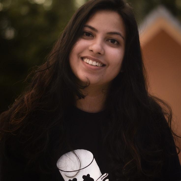 Kaveri Mehta, Lead Design Curator at BreezeFieldAtlas, reviewing corporate floral arrangements